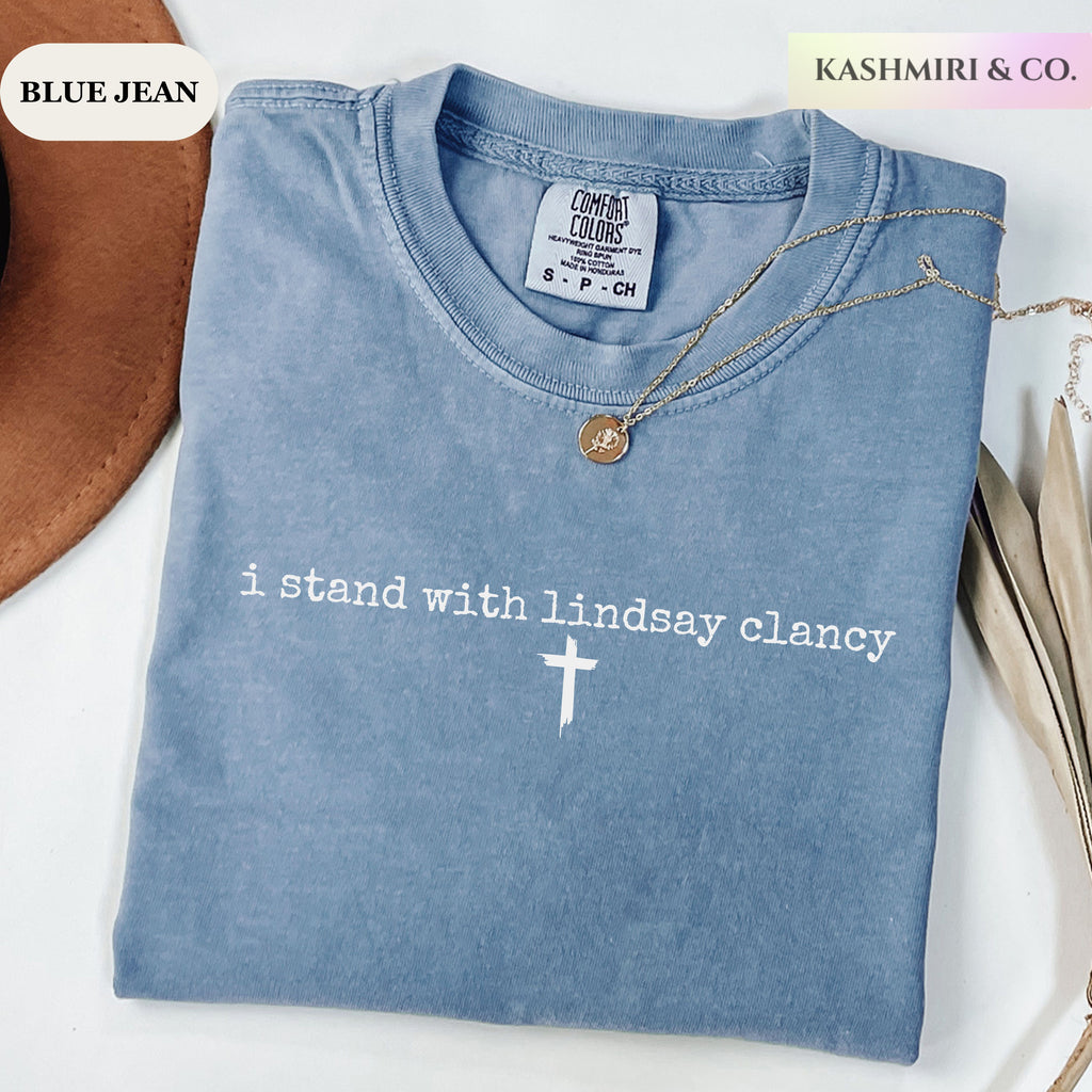 i stand with lindsay clancy tee with a holy cross on a blue jean comfort colors tee